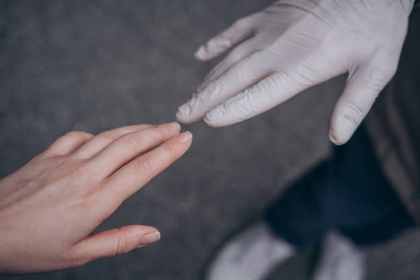 istock Two hands of a couple one in a plastic glove virus protect 1283390226