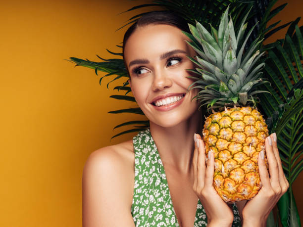 istock Beautiful girl with pineapple 1283390970