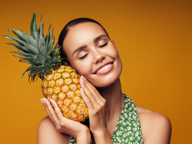 istock Beautiful girl with pineapple 1283391079