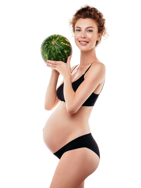 istock Pregnant woman holding a watermelon 1283391396
