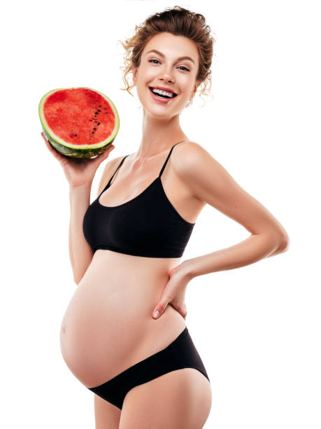 istock Pregnant woman holding a watermelon 1283391432
