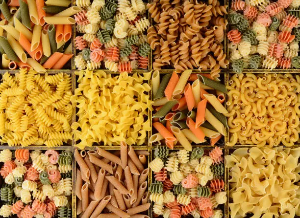 Overhead Closeup view of a divided box filled with different pastas.