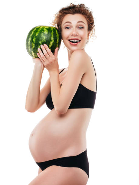 istock Pregnant woman holding a watermelon 1283391477