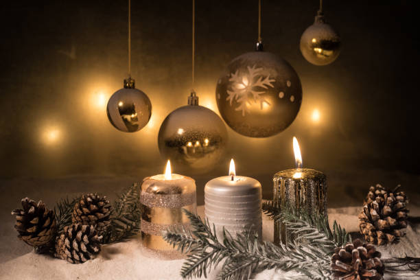 istock Creative artwork decoration. Christmas decoration with burning candles on a dark background. Christmas ornaments over dark golden background with lights. 1283392264