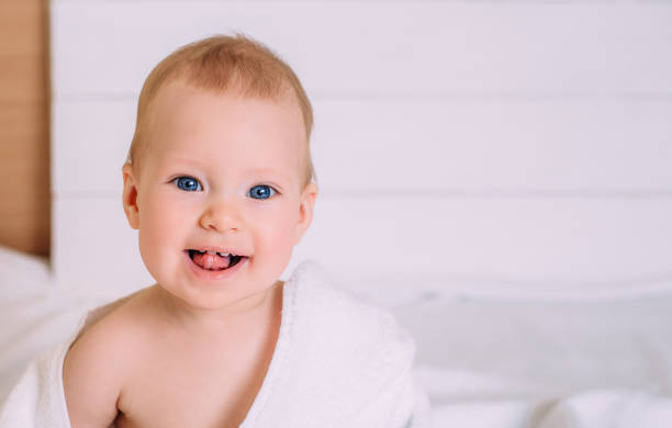 istock Cute baby with blue eyes wrapped in a white towel. 1283392566
