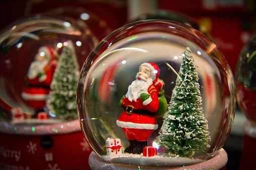 Snowball. Crystal ball with Santa Claus and a fir tree inside. Christmas