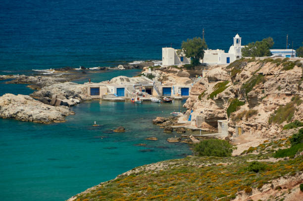 Colourful boathouses in idyllic setting against the turquoise Aegean sea