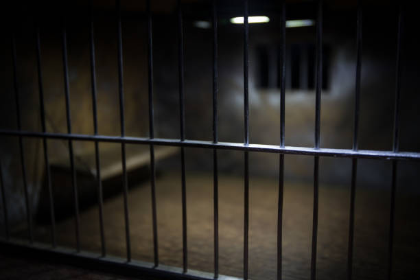 istock Jail or prison cell. Old grunge prison miniature. Dark prison interior creative decoration. Empty cell. Selective focus Obsolete gray grunge concrete room. 1283394051