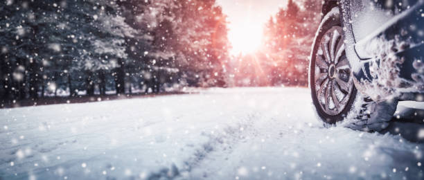 istock Car tires on winter road covered with snow 1283395904