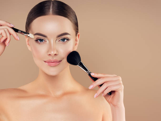 istock Beautiful young woman applying foundation powder 1283396195