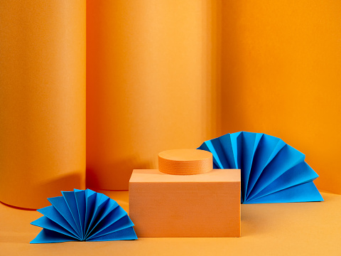 Minimal abstract bright orange background, the layout of the scene with the geometrical form of a podium for demonstration of product