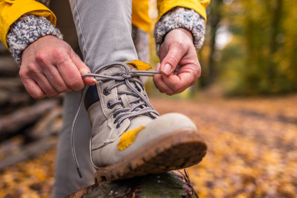 istock Hiker ties shoelaces on her leather hiking boot 1283397344