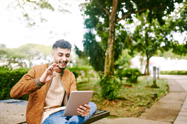 istock Young Arab Adult using Tablet Outdoor 1283397489