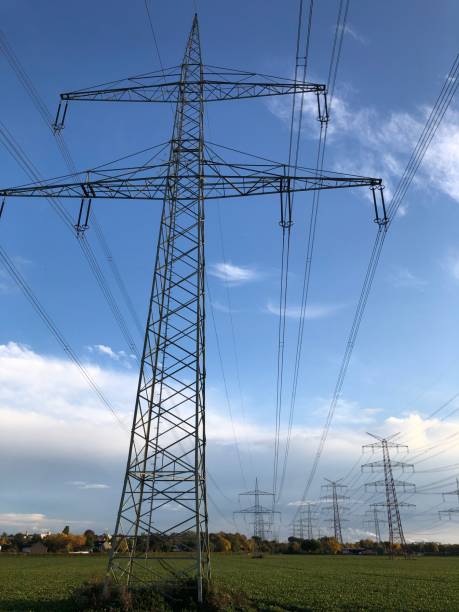 istock Electricity pylons against a blue sky with few clouds 1283398557