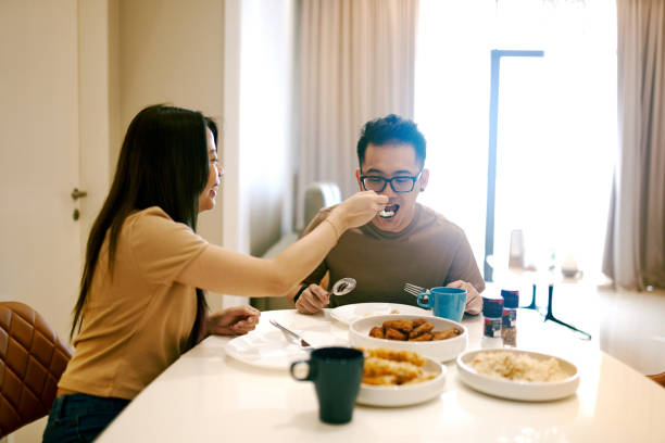 istock Beautiful Chinese Couple Eating Together at Dining Table 1283398614