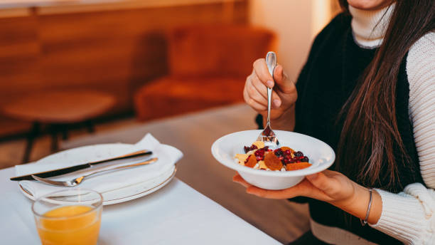 istock Young woman eating a oatmeal with berries 1283398658