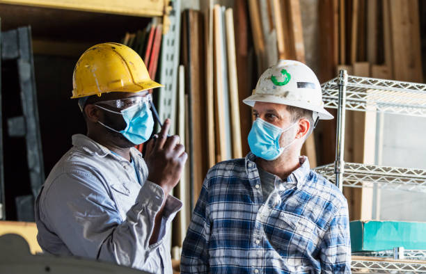 istock Two men working in warehouse, wearing face masks 1283398710