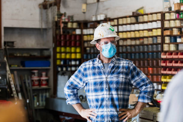 istock Man working in manufacturing plant, wearing face mask 1283399790