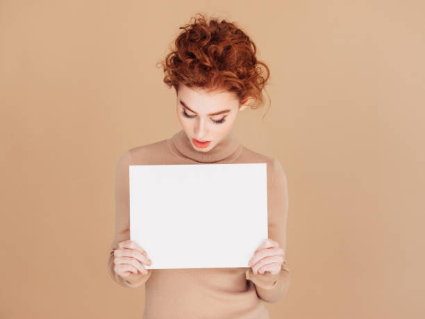 istock Beautiful woman holds placard 1283399965
