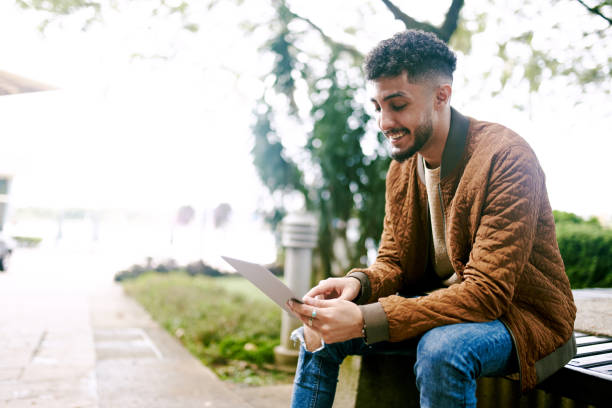 istock Young Arab Adult using Tablet Outdoor 1283401238