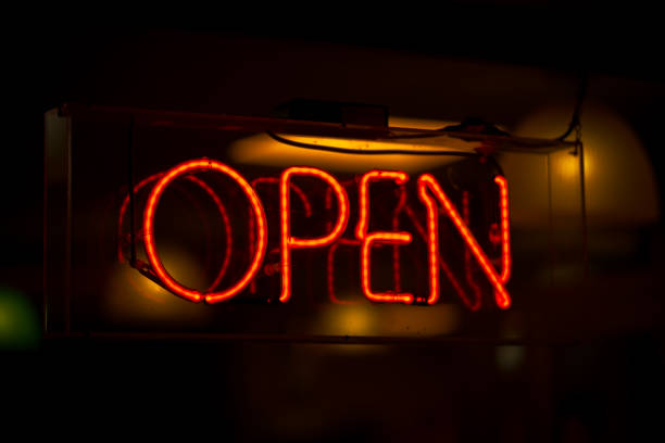 istock Open neon sign in red with dark background, in shop window 1283401977