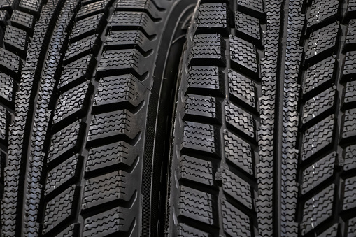 Texture of a new winter tires for car closeup.