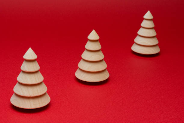 istock Wooden Christmas tree figurine on a red background. Copy space. 1283403462
