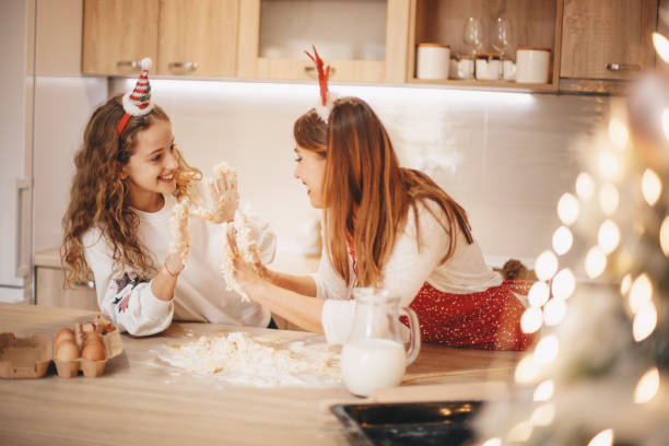 istock Two girls mixing dough, having fun. Christmas concept. 1283405727