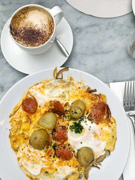 istock Crushed fried egg, potatos and chorizo for brunch with a cup of flat white coffee 1283405787