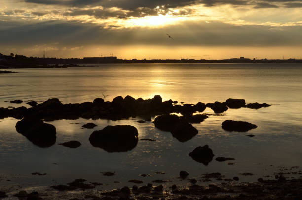 Sun setting over Dublin bay,Republic of Ireland. stock photo