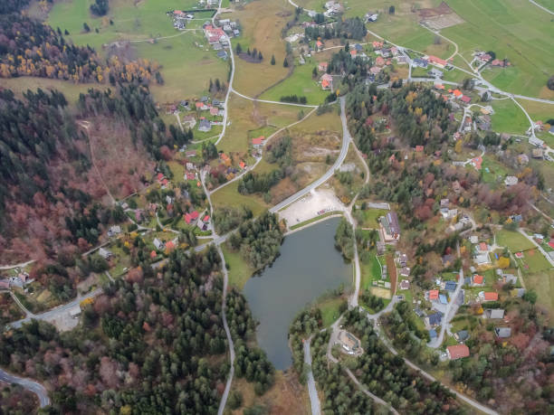 istock road in the autumn forest drone view 1283406633