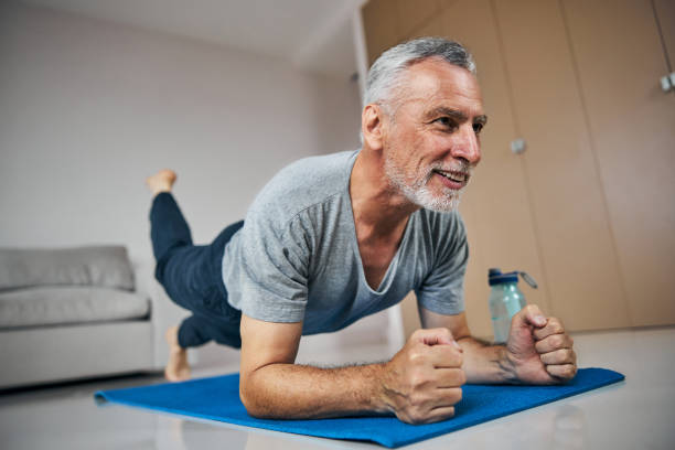 istock Fit aged man training his muscle endurance in plank position 1283406701