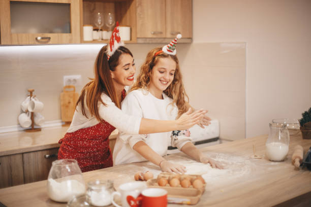 istock Girls spreading flour on working surface to knead a dough. 1283406892