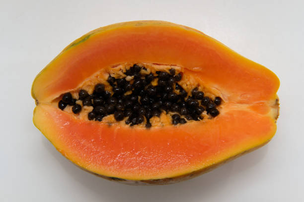 istock Cutted papaya on top of a white cutting board 1283407911