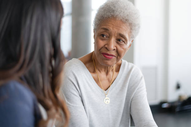 istock Visiting nurse meets with patient 1283408814
