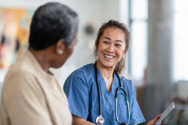 istock Visiting nurse meets with patient 1283408816