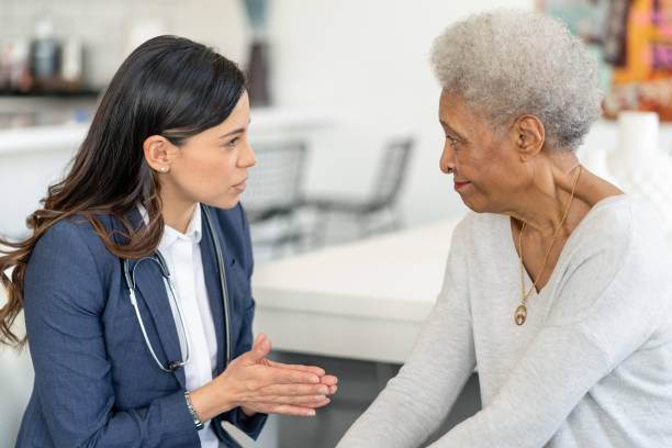 istock Visiting nurse meets with patient 1283408828