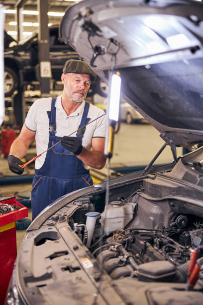 istock Serious bearded man working at auto repair service station 1283409954