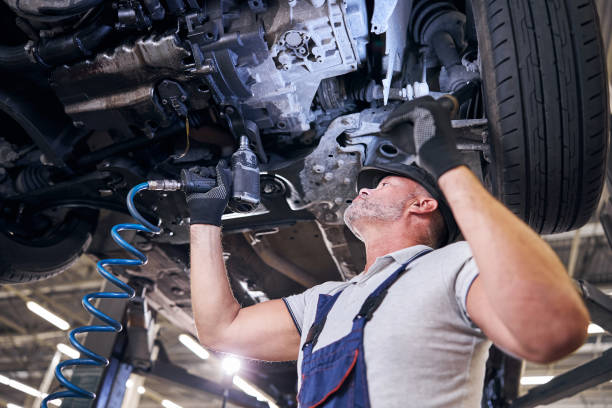 istock Bearded male worker using impact wrench in garage 1283409995