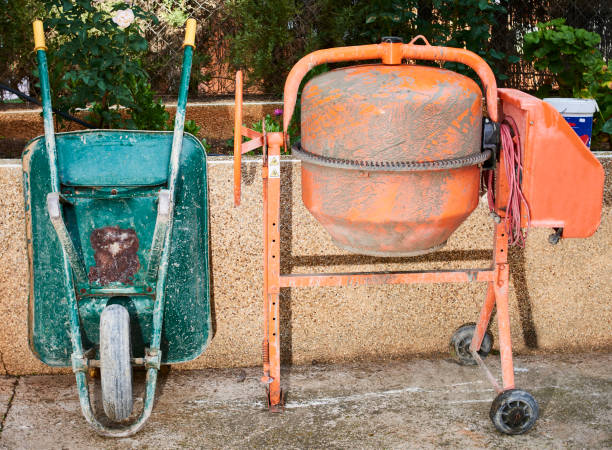 istock Wheelbarrow and concrete mixer for mixing and making cement and concrete on a construction site 1283410585