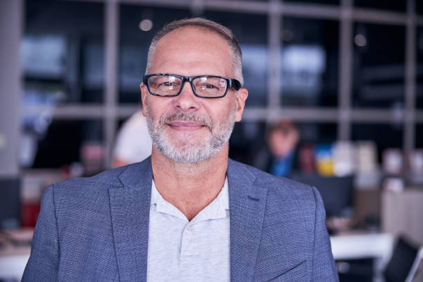 istock Handsome bearded man in glasses expressing positive emotions 1283411725