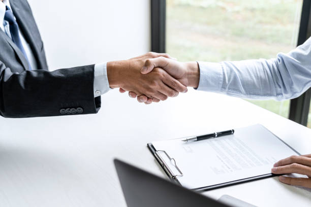 istock Greeting new colleagues, Handshake while job interviewing, male candidate shaking hands with Interviewer or employer after a job interview, employment and recruitment concept 1283414337