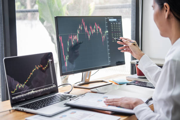 istock Businesswoman working with computer, laptop, thinking and analyzing graph stock market trading with stock chart data planning, financial and investment concept 1283414342