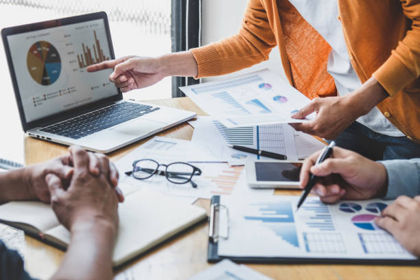 istock Business team meeting to conference, collaboration discussing working analyzing with financial data and marketing business strategy project, presentation and brainstorming to making profit of company 1283414347