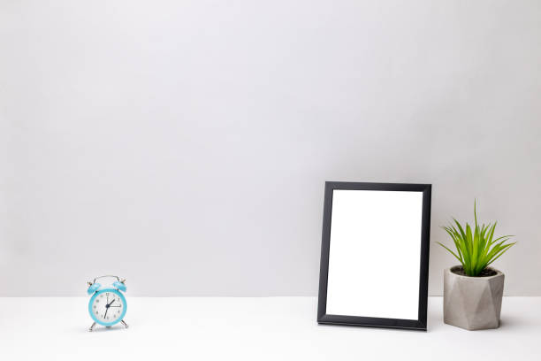 istock blank frame mockup on a white desk. gray wall background. office or home workplace. work planning concept. greeting card template 1283414382