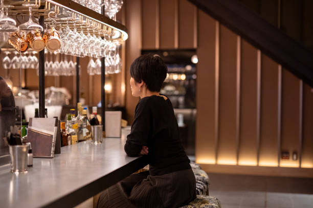 Side view of woman at bar