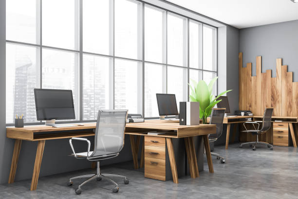 istock Gray and wooden open space office corner 1283414594