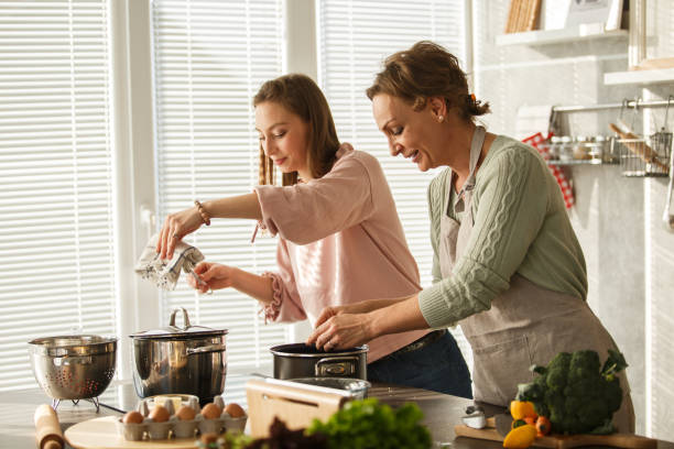 istock Mother and daughter cooking lunch in teamwork 1283414606