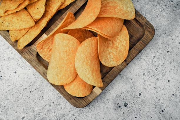 istock Chips, snacks and crackers on a wooden board. Fast food. 1283414608