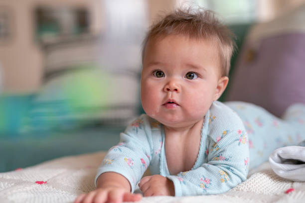 istock Happy baby doing tummy time 1283414792